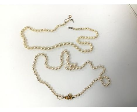 A cultured pearl necklace with 9ct gold clasp and safety chain, string detached between two pearls (l.25cm) and another pearl