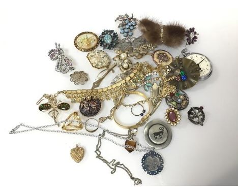 An assortment of costume jewellery including a silver thistle badge, paste and glass brooches, tie clips, necklaces, pocket w