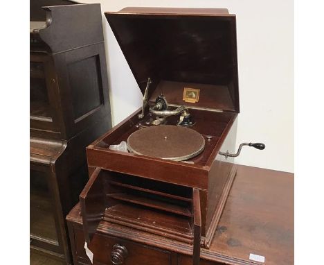 A vintage HMV gramophone, inscribed His Master's Voice, no.4 with hinged lid above a pair of doors (35cm x 48cm x 46cm)