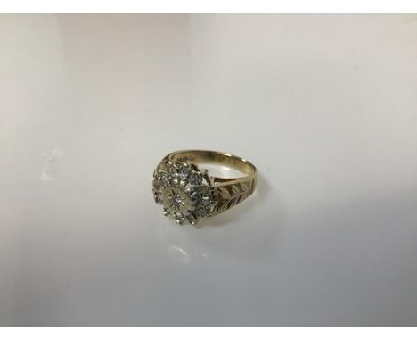 A 9ct gold diamond cluster ring in a flowerhead setting with leaf cast shoulders (O) (4.88g)