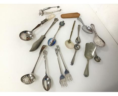 A silver pierced spoon (l.12cm) (17.98g) and an assortment of caddy spoons, cocktail forks, souvenir spoon, sugar tongs etc. 