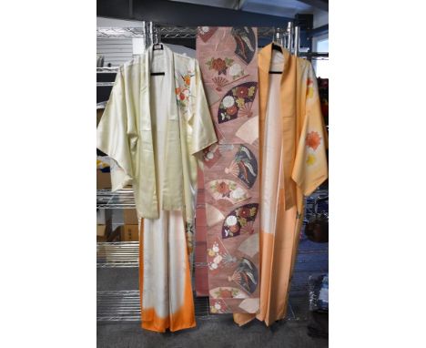 Two attractive Japanese Kimonos, each decorated with blossoms and sold along with a decorative Obi with repeating fan designs