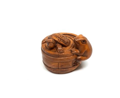 A carved hardwood Chinese netsuke - Frog and Turtle in barrel