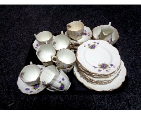 A tray containing a thirty-eight piece antique floral patterned bone china tea service  