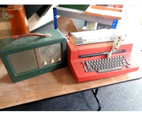 An IBM electric typewriter (continental wiring) together with a green leather cased receiver    
