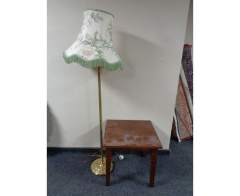 A contemporary square coffee table together with a brass table lamp with shade  