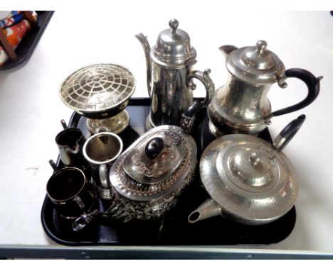 A tray containing plated wares to include a Roundhead leadless pewter teapot and coffee pot, silver plated tea wares, tankard