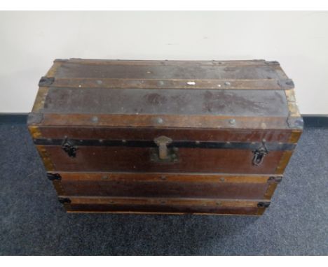 An early 20th century wooden bound dome topped shipping trunk  