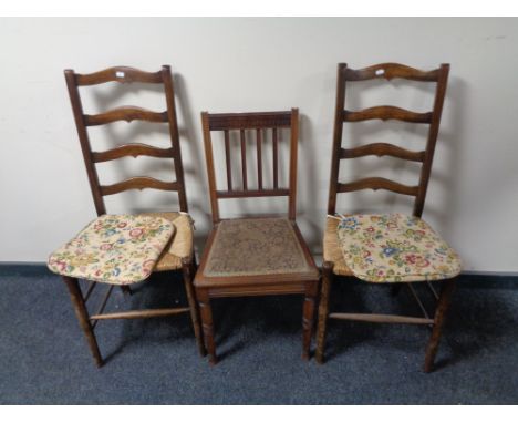 A pair of Edwardian ladder back rush seated bedroom chairs together with a further mahogany bedroom chair  