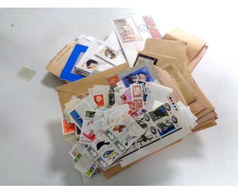 A box containing assorted stamps and first day covers  