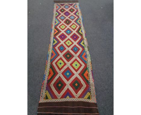 A Suzni kilim runner, 315cm by 80cm