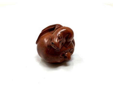 A carved hardwood Chinese netsuke - Two rats in a pumpkin
