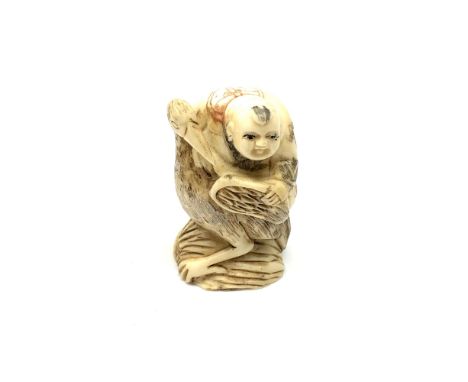 A carved bone Chinese netsuke - Man riding a large bird