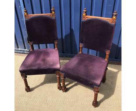 A pair of late Victorian carved walnut framed hall chairs in the Gothic Revival taste, the upholstered backs with dragon scal