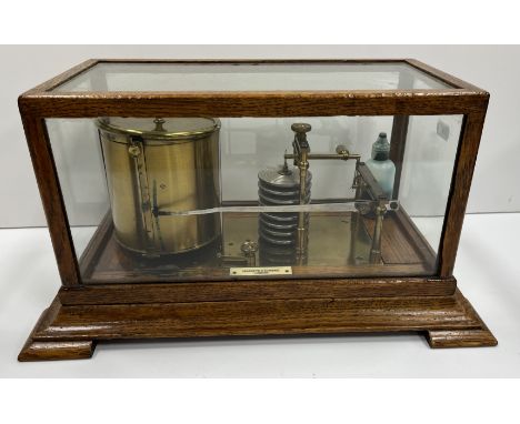 A Negretti & Zambra of London oak cased barograph of typical form, on a swept plinth base, to bracket feet, 35.5 cm wide x 21