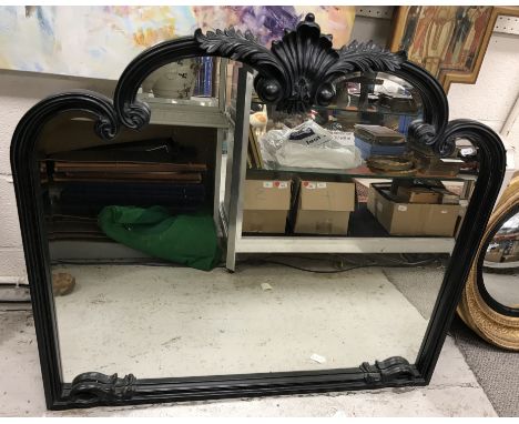 A modern ebonised framed mantel mirror in the Victorian style with foliate decorated pediment and moulded decoration, 101 cm 
