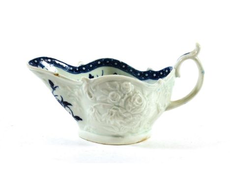 A Worcester Porcelain Sauceboat, circa 1765, painted in underglaze blue with The Sauceboat Peony pattern on a foliate moulded