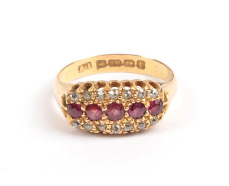 An 18 Carat Gold Ruby and Diamond Ring, 1905, a row of five graduated round faceted rubies flanked top and bottom with a row 