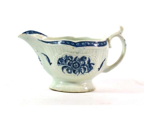 A Worcester Porcelain Sauce Boat, circa 1770, printed in underglaze blue with The Strap Flute Floral pattern on a moulded gro