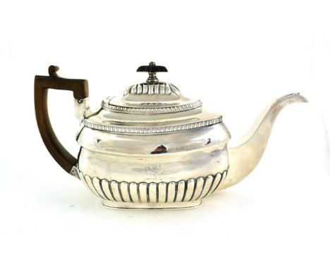 A George III Silver Teapot, by William Bennett, London, 1807, shaped part-fluted oblong, with wood handle, engraved with a cr