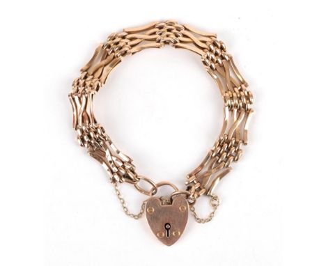 A Gate Bracelet, crossover gate links alternate with textured links, with a heart shaped padlock clasp, length 20cm .  The br