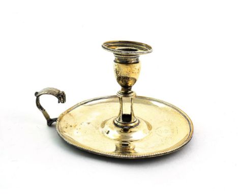A George III Silver Chamber-Candlestick, by Robert Hennell, London, 1784, circular and with beaded rim, the central socket wi