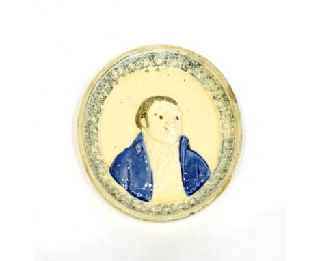 A Pratt Type Earthenware Portrait Plaque, circa 1805, modelled with a bust portrait of a gentleman wearing a blue jacket with