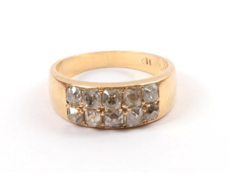 A Late 19th Century Two Row Diamond Ring, the old mine cut and old European cut diamonds in yellow claws to a plain polished 