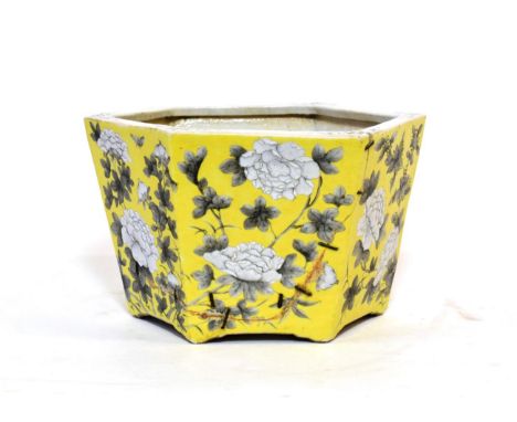 A Chinese Porcelain Hexagonal Planter, 19th century, painted en grisaille with flowering peony on a yellow ground, 27.5cm wid