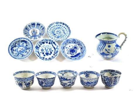A Chinese Porcelain Tea Bowl and Saucer, Kangxi, painted in underglaze blue with panels of foliage, four character Kangxi rei