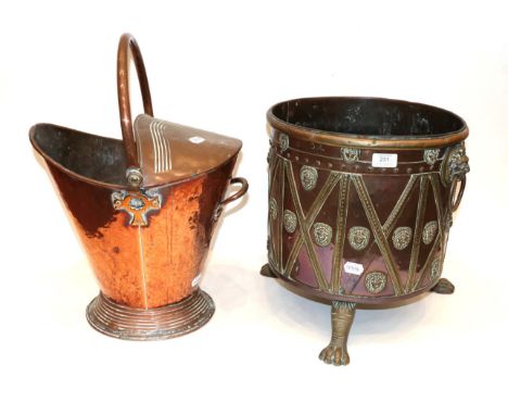 A Regency Style Brass and Copper Circular Planter, late 19th century, the body with decorative strapwork and lion masks, on t