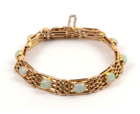 An Opal Bracelet, circa 1910, the gate links set with oval opals in collet settings, length 17.2cm .  The bracelet is in good
