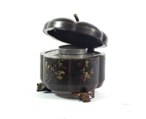 A Chinese Export Lacquer Tea Caddy, mid 19th century, of hexafoil form with stem handle and scroll feet, painted in gilt with