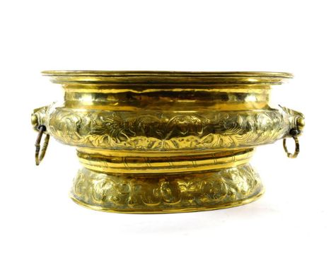 A Dutch Brass Wine Cistern, late 17th/early 18th century, of oval form with everted rim and lion mask and loop handles, on an