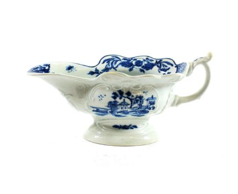 A Worcester Porcelain Sauceboat, circa 1755, painted in underglaze blue with The Triangular Platform pattern within scroll bo