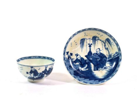 A Worcester Porcelain Tea Bowl and Saucer, circa 1765, painted in underglaze blue with The Gardener pattern 
