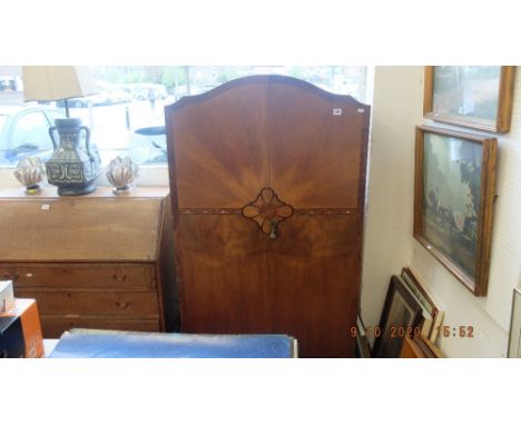 A walnut fitted wardrobe, inlaid with mother of pearl