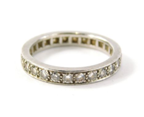 An 18ct white gold diamond eternity ring, set with around twenty eight round brilliant cut diamonds, in four claw setting, ri