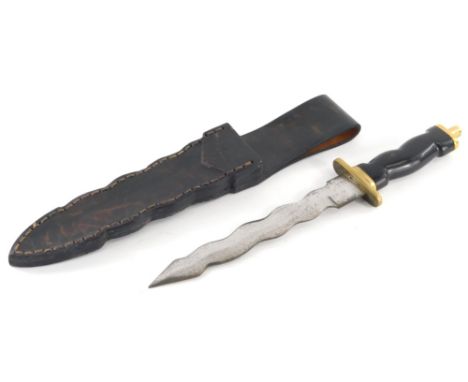 A 20thC serpentine bladed dagger, with turned handle, brass mounts, compressed pommel, and leather scabbard, and leather hols