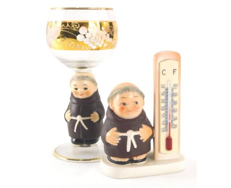 Various early 20thC Goebel monk figures, 1956 KF thermometer, 12cm high, and drinking glass with monk stem. (2)