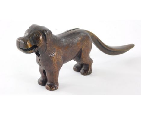 A 20thC standing bronze effect cast iron dog nutcracker, with articulated mouth and tail.
