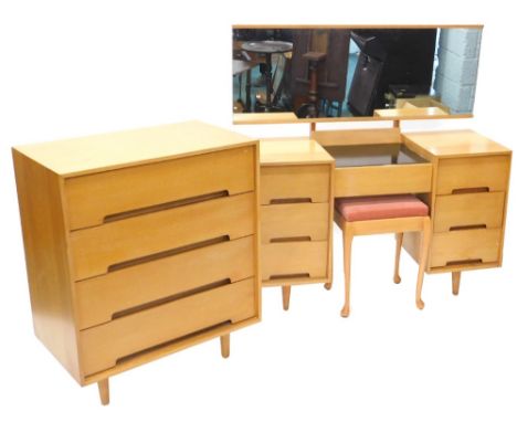An early Stag light oak chest of drawers, of plain form with four long drawers each with integral handles on turned tapering 