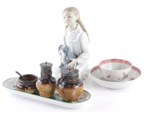 A Nao figure of a girl seated holding puppy, printed marks beneath, 20cm high, an early 19thC Newhall tea bowl and saucer, ov