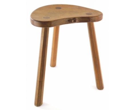 A 1970s Robert Thompson of Kilburn Mouseman oak cow stool, with saddle seat carved with mouse to the side on three legs, 46cm