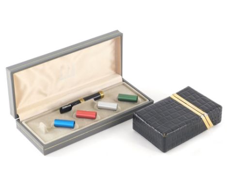 A crocodile skin style leather cigarette case,&nbsp; with gilt metal mounts, 18cm wide, and a Dunhill cigarette holder set.