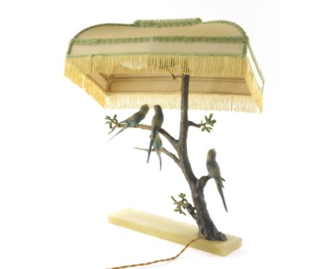 A 1920s cold painted bronze table lamp, set with four budgerigars on entwined floral branches and a green onyx base, 34cm wid