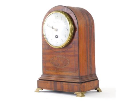 An Edwardian satinwood table clock, the domed 10cm diameter Arabic dial in an arched case, on compressed metal bracket feet, 