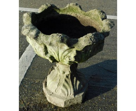 A concrete planter with floral head, on inverted stem and shaped foot, 50cm high, 51cm wide.