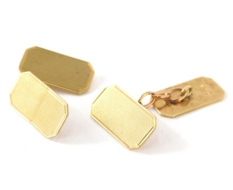 A pair of 9ct gold cufflinks, engine turned with canted corners and chain centres, 2cm high, 5g. (2)