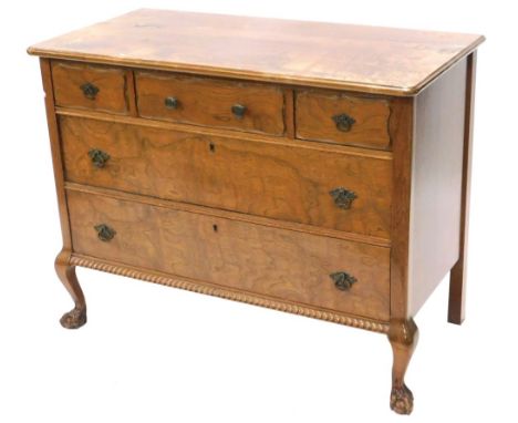 A continental walnut commode, the rectangular top with a moulded edge above an arrangement of three short and two long drawer